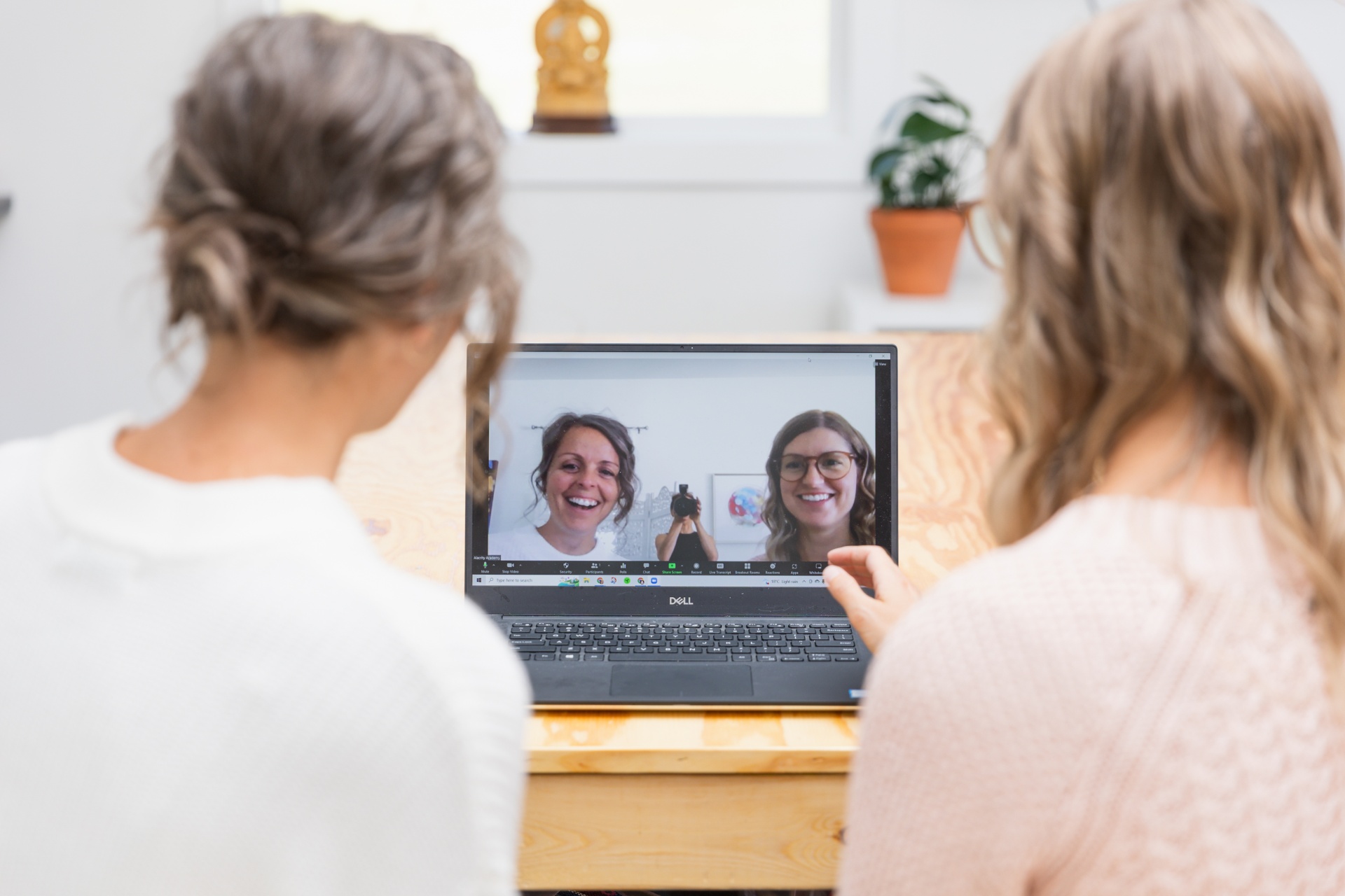 Over-the-shoulder view of a video call between the Adams Digital team and a client